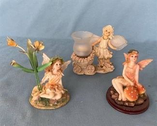 Three fairy figurines approximately 6 inches tall - one with votive