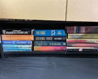 Shelf of approximately 14 hardback novels