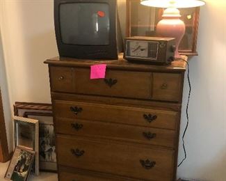 chest of drawers, lamp, vintage alarm clock, small tv