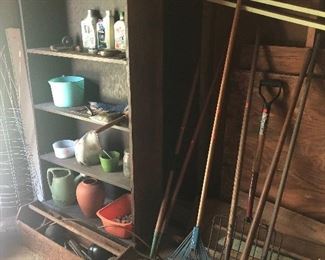 long handled garden tools, wooden bookshelf, wooden tool box