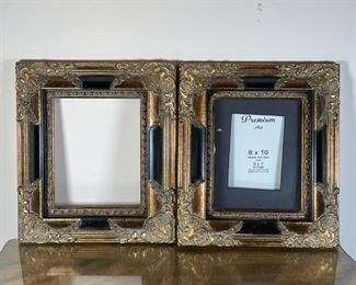PAIR GILT CARVED FRAMES | Matching picture frames, 8 x 10 in. black mat with a 5 x 7 in. insert/sight, the black frames with gilt decoration and carved acanthus leaf motifs; overall 16 x 14 in. 