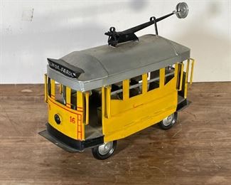 PAINTED TIN TROLLEY CAR | "OLINDA-FAROL" yellow painted tin trolley car; car h. 7-1/2 x w. 5 x l. 12-1/4 in. 