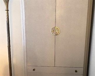 Beige linen-wrapped tall chest  with Asian hardware