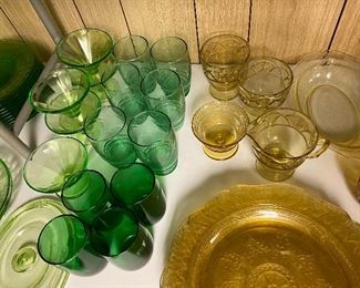 Huge assortment of green, yellow and pink depression glass