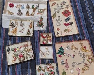 Large collection of vintage Christmas pins including tree, reindeer, snowman, santa's, wreaths, and presents!