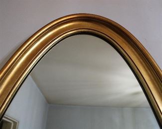 Top of frame detail on large elongated oval mid century gilt mirror
