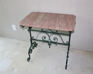 Gorgeous antique c. 1920's pink marble topped hand wrought iron table 30" wide, 20" deep, and 30" tall.  Note the rounded edge on the marble top (and the canted corners!) in superb antique condition!