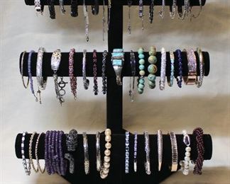 Large assortment of contemporary sterling silver and semi precious gemstone bracelets, bangles, and cuffs including opals, amethysts, pearls, turquoise, black spinels, apatite, and garnets.