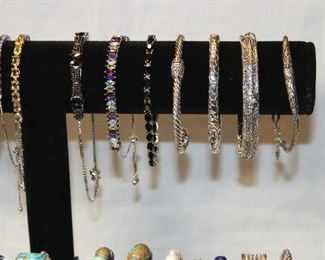 Detail of large assortment of contemporary sterling silver and semi precious gemstone bracelets, bangles, and cuffs including opals, amethysts, pearls, turquoise, black spinels, apatite, and garnets.