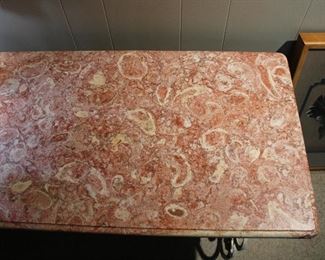 Lovely pink marble top on the patisserie style table