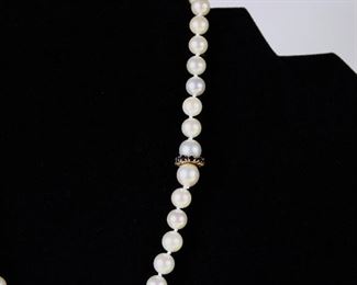 Strand of 7 mm saltwater pearls with an unusual gold and sapphire clasp.  16" long.