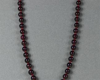 Gorgeous saturation on these 7 mm garnet beads, 18" long, knotted between each bead and with a 14K gold clasp.