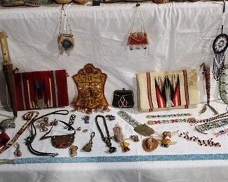 Several examples of antique beadwork including hat bands, necklaces, pins/brooches, earrings, bracelets, coin purse, hanging bags/boxes, and two woven wool chimayo purses, one made for Fred Harvey