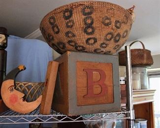 Great old African basket on top of a wonderfully cute child's step stool in the form of a wooden block!