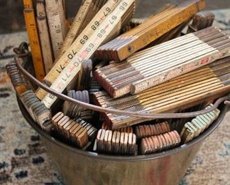 A brass bucket full of old folding yardsticks!