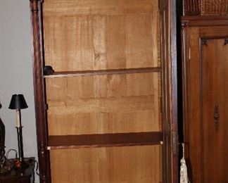 Interior of armoire is currently fitted with shelves