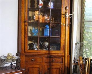 Superb example of an American 19th century corner cupboard with individually glazed glass panes.