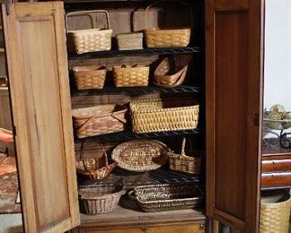 Interior of armoire with a very few of the multiple baskets we have for sale!