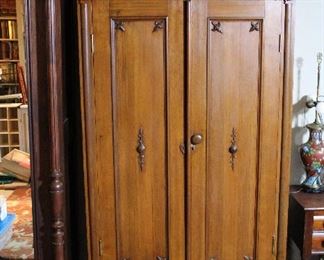 A smaller armoire with carved details