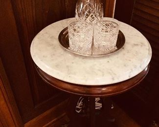 Marble top table and crystal bar ware. 