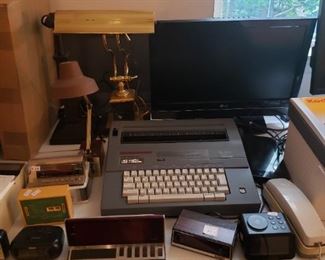Electric Typewriter, various alarm clocks, monitors and desk lamps