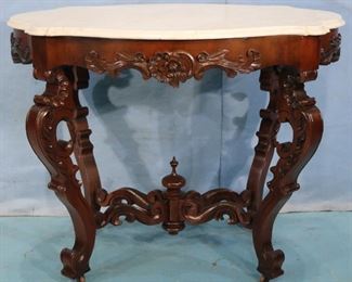 51 - Walnut rococo oval heavily carved center parlor table, 30 in. T, 38 in. W, 26 in. D.