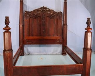 78 - Mahogany carved four poster plantation bed with flamed finials and heavily carved headboard, 93 in. T, 62 in. W, 75 in. L.