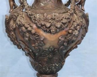 35 - Bronze capped urn with cupids blowing trumpets and applied roses, 42 in. T, 22 in. W.