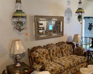 Matching pair of flowers oil lamp chandeliers overstuffed couch