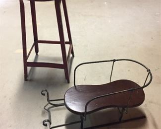 Metal stool and decorative sled.