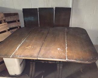 Antique table with several leaves.