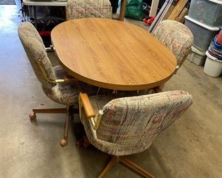 Vintage dining table and 4 roller chairs - Brand unknown.  Covers clean and in good condition