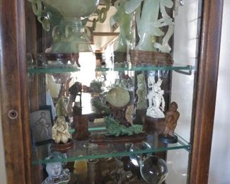 Top Shelf: Carved Celadon Jade  Maiden; Pierce-Carved Celadon Jade Footed Senser w/ Lid: 2nd. Shelf: Small Pierce-Carved Celadon Jade Medallion; Antique Bone "Two-Faced" Netsuke; Nephrite Carved Dragon; Bottom Shelf: Carved Agate Foo Dog on Stand; Antique Grand Tour Globe on Gilt Stand 