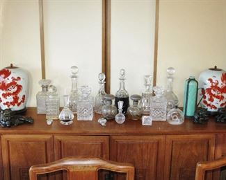 Chinese-Style Buffet w/ a Fine Collection of Crystal Decanters; Pair of Vintage Russet Foo Dog Ginger Jars w/ Wood Lids; Pair of Small Reclining Foo Dogs; Larger Reclining Foo Dog, possibly an inkwell