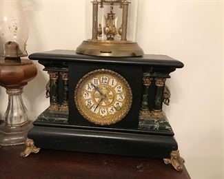 Beautiful Marble and Slate Pillar Mantel Clock with gilded trim and feet.  Clock has been made into an electric clock.  Someone who loves clocks can restore to its original beauty.