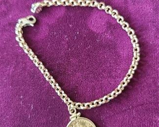 14k chain bracelet with 22k gold coin total weight 13.7 grams. The length is 7 and 3/4. Price $525