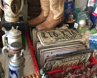 Three flats of license plates, collection of beer steins, and an old Clydesdale cast iron beer horse wagon! Check out those cowboy boots.