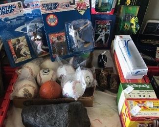 Various sports items including balls, bobble heads, basketball trading cards and more.