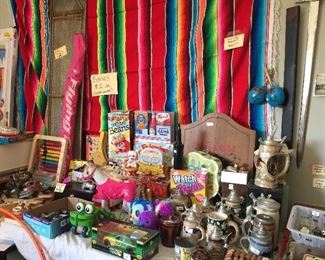 Childrens games, dart board, kite, etc., beautiful rainbow color blanket, some old metal cars, metal toboggan