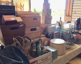 Several tables of housewares and misc. boxes and storage containers.  Note the vintage 7-up crate.