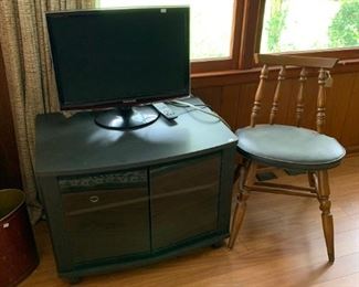 Small television with wooden chair 