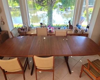 Teak dining table with 2 leaves. 6 chairs
