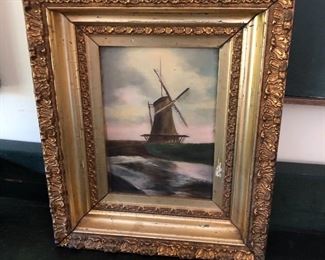 Antique painting of windmill on board and in ornate frame.