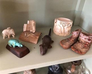 Various carvings/figurines in ivory and other materials.