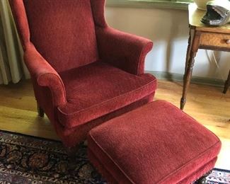 Wingback chair and ottoman upholstered with diamond-pattern corduroy and cording around bases.