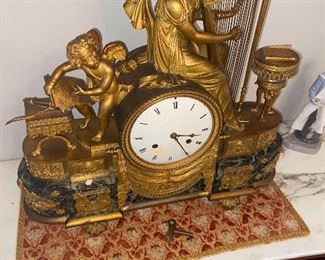Amazing gold guild ormolu(?) Figurative mantle clock with Cupid and harp, marble base, porcelain face, marked Fiumi 1867 Milano.    $595 obo 