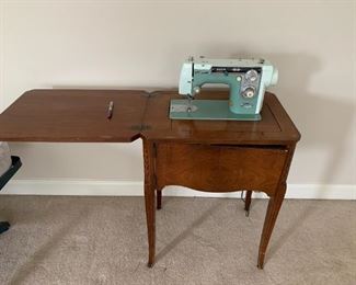 #36	Cabinet	New Home Metal Sewing Machine in Machine	 $ 50.00 																						