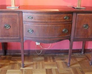 #27 Mahogany server.  Sheraton style.  Storage drawers and cabinets.  Cast brass pull handles.  Banded satinwood outline the drawers.  C. 1930.   37.5” X 16” X 22.5” 