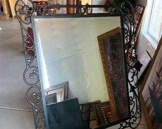 Metal framed mirror matches king bed.