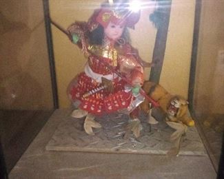 100. ORIENTAL  DOLL IN CASE WITH TIGER 